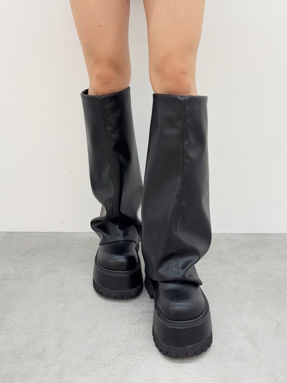 ブラック系のブーツ、ブルー系のデニムスカート、レッド系のニット/セーターを着用したレディースの夏コーディネートの6枚目の写真