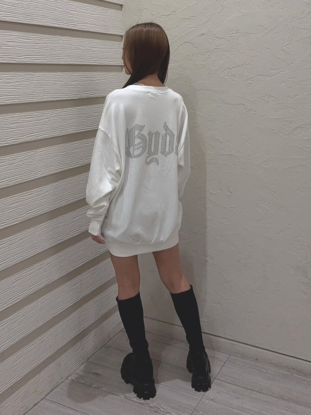 ブラック系のブーツ、ホワイト系のパーカーを着用したレディースの秋コーディネートの3枚目の写真