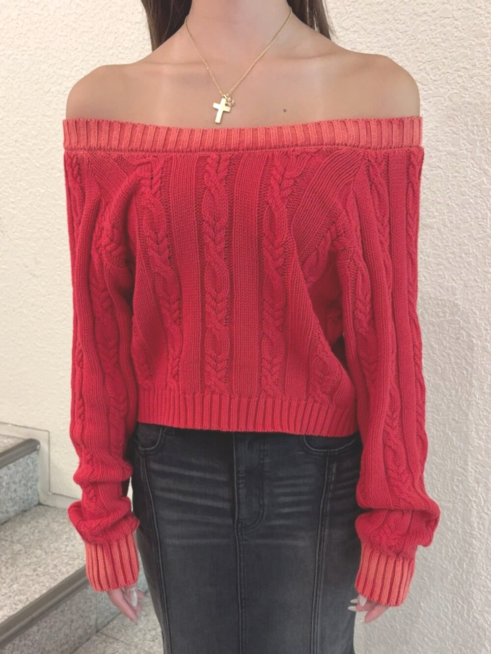 ブラック系のブーツ、レッド系のニット/セーター、ブラック系のデニムスカートを着用したレディースの秋コーディネートの4枚目の写真