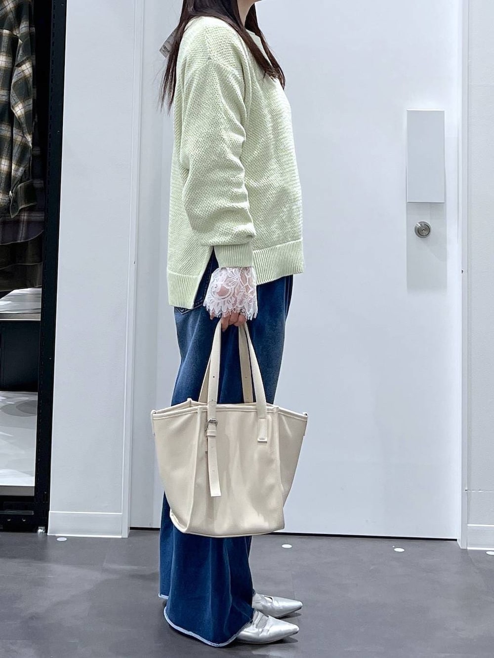 シルバー系のパンプス、ホワイト系のトートバッグ、ブルー系のその他パンツを着用したレディースの春コーディネートの2枚目の写真