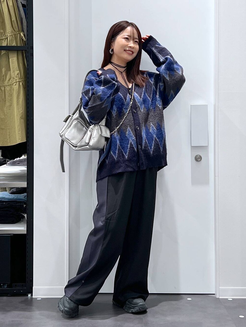 ブルー系のカーディガン/ボレロ、ブラック系のブーツ、その他のショルダーバッグを着用したレディースの秋コーディネートの2枚目の写真