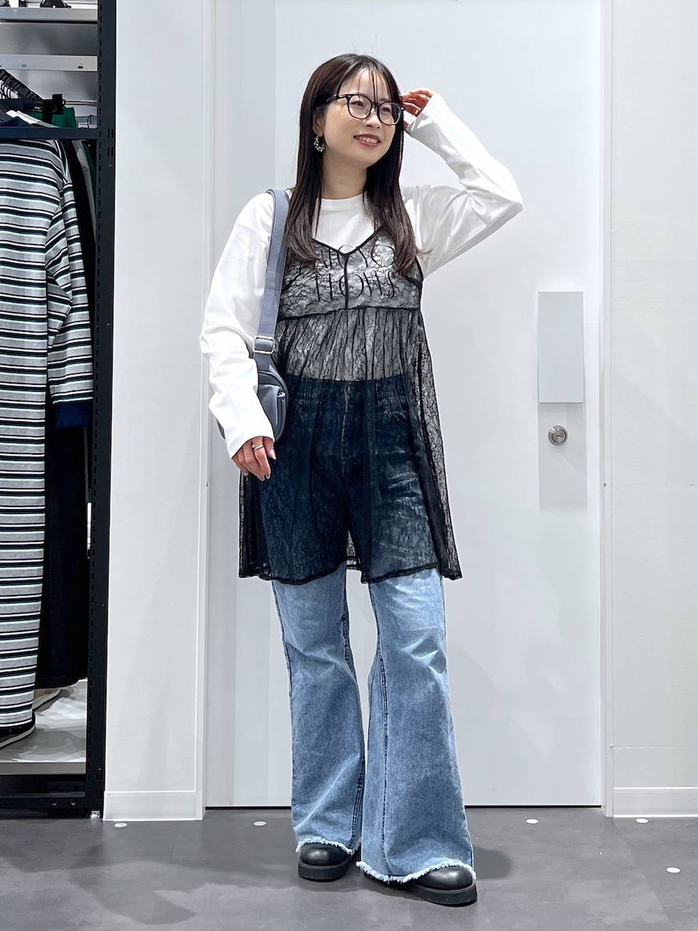 ブルー系のショルダーバッグ、ホワイト系のTシャツ/カットソー、ブラック系のサンダルを着用したレディースの春コーディネートの4枚目の写真