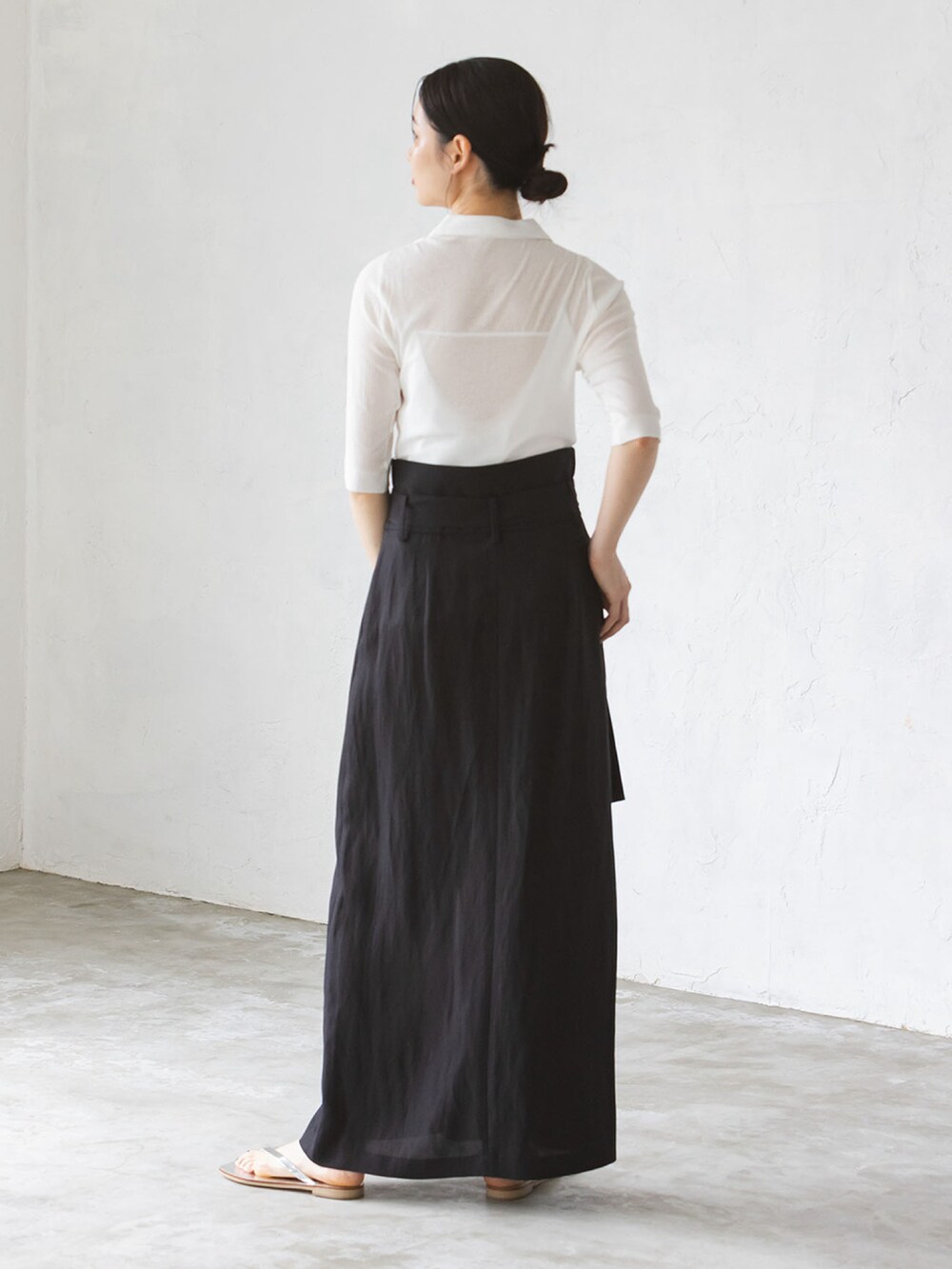 ブラック系のスカート、シルバー系のサンダルを着用したレディースの夏コーディネートの2枚目の写真