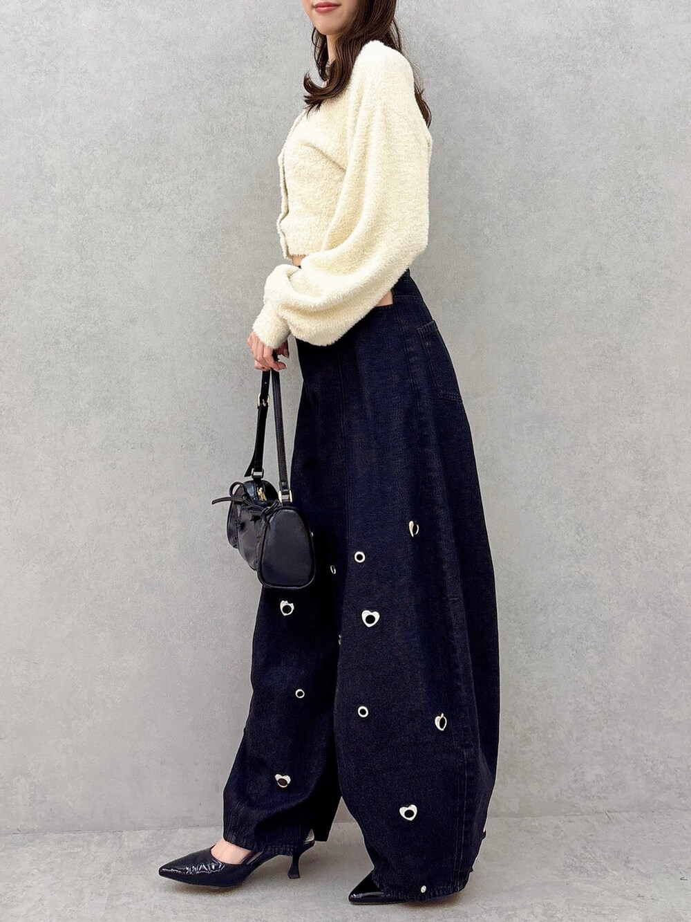 ベージュ系のカーディガン/ボレロ、ブルー系のデニムパンツ、ブラック系のパンプスを着用したレディースの冬コーディネートの4枚目の写真