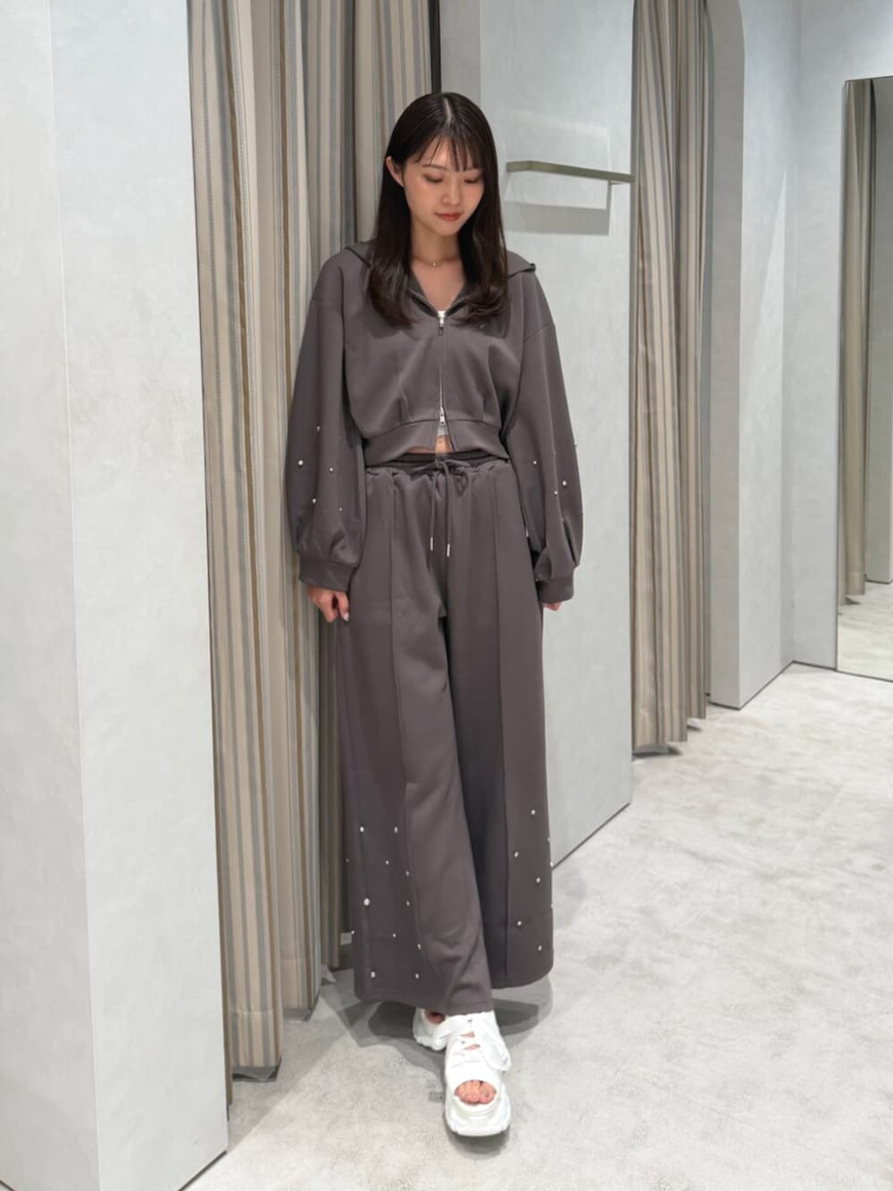 ブラウン系のTシャツ/カットソー、ブラウン系のスウェットパンツ、ホワイト系のサンダルを着用したレディースの夏コーディネートの2枚目の写真