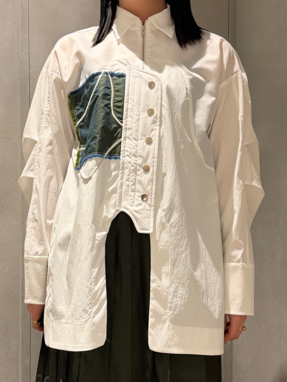 ホワイト系のシャツ/ブラウス、グリーン系のスカート、シルバー系のブーツを着用したレディースの春コーディネートの4枚目の写真