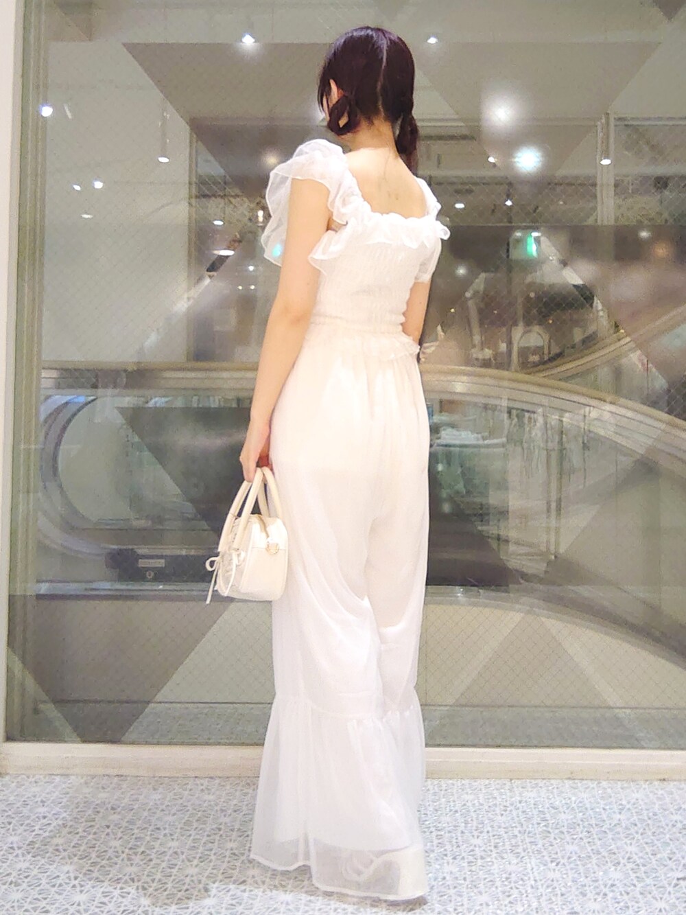 ホワイト系のその他パンツ、ホワイト系のショルダーバッグ、ホワイト系のサンダルを着用したレディースの夏コーディネートの3枚目の写真