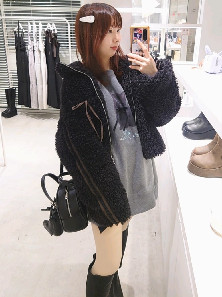 ブラック系のブルゾン、グレー系のスウェット、ブラック系のハンドバッグを着用したレディースの冬コーディネートの2枚目の写真