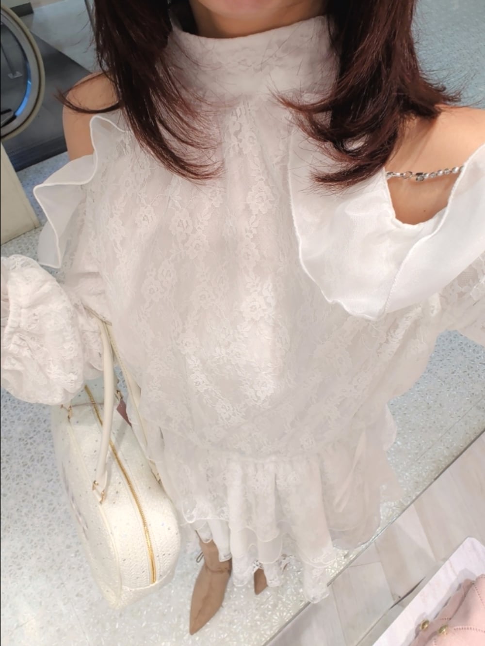 ホワイト系のシャツ/ブラウス、ホワイト系のボストンバッグ、ベージュ系のブーツを着用したレディースの冬コーディネートの3枚目の写真