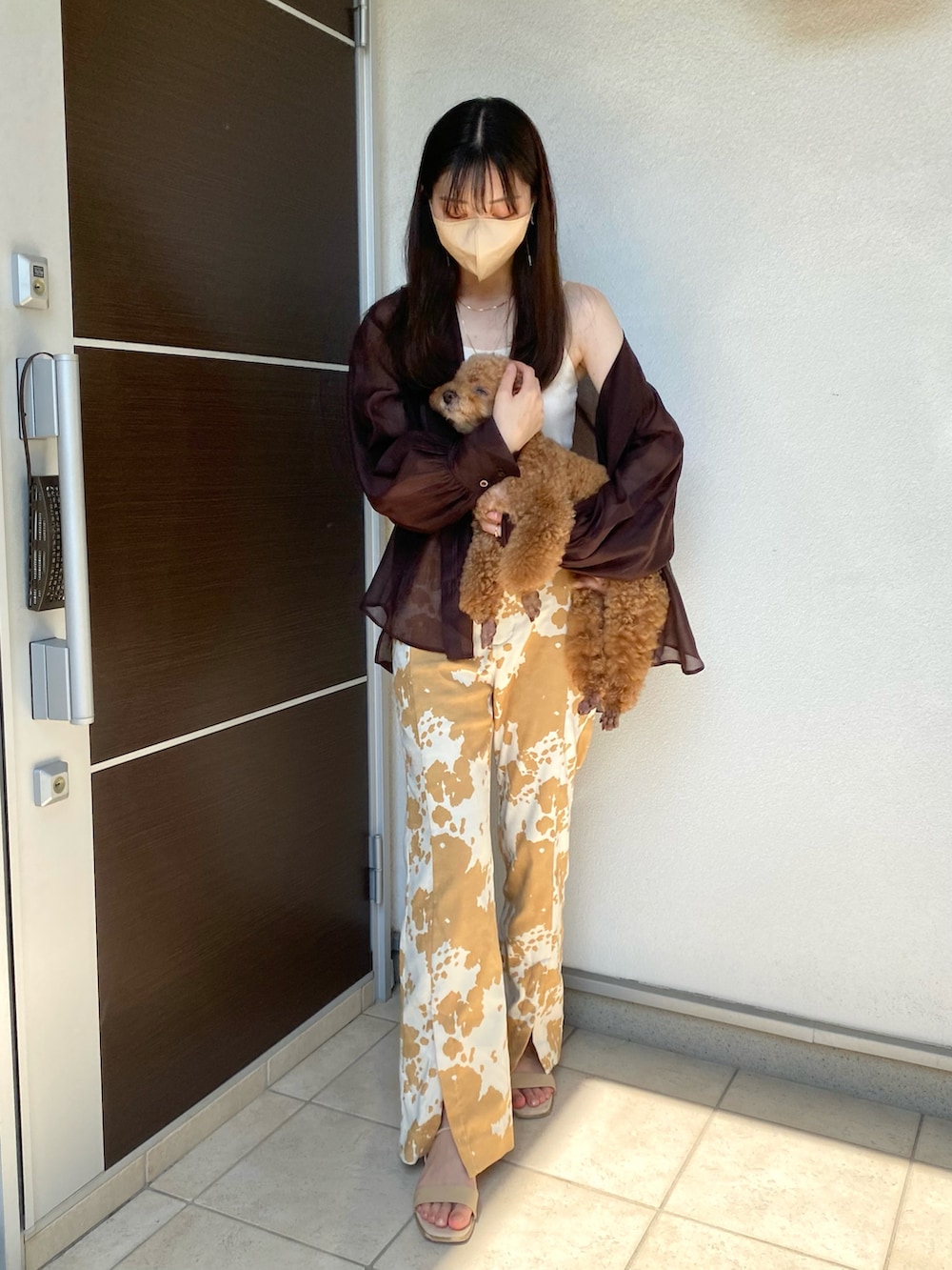 ホワイト系のキャミソール、ブラウン系のシャツ/ブラウス、ベージュ系のスラックスを着用したレディースの秋コーディネートの3枚目の写真