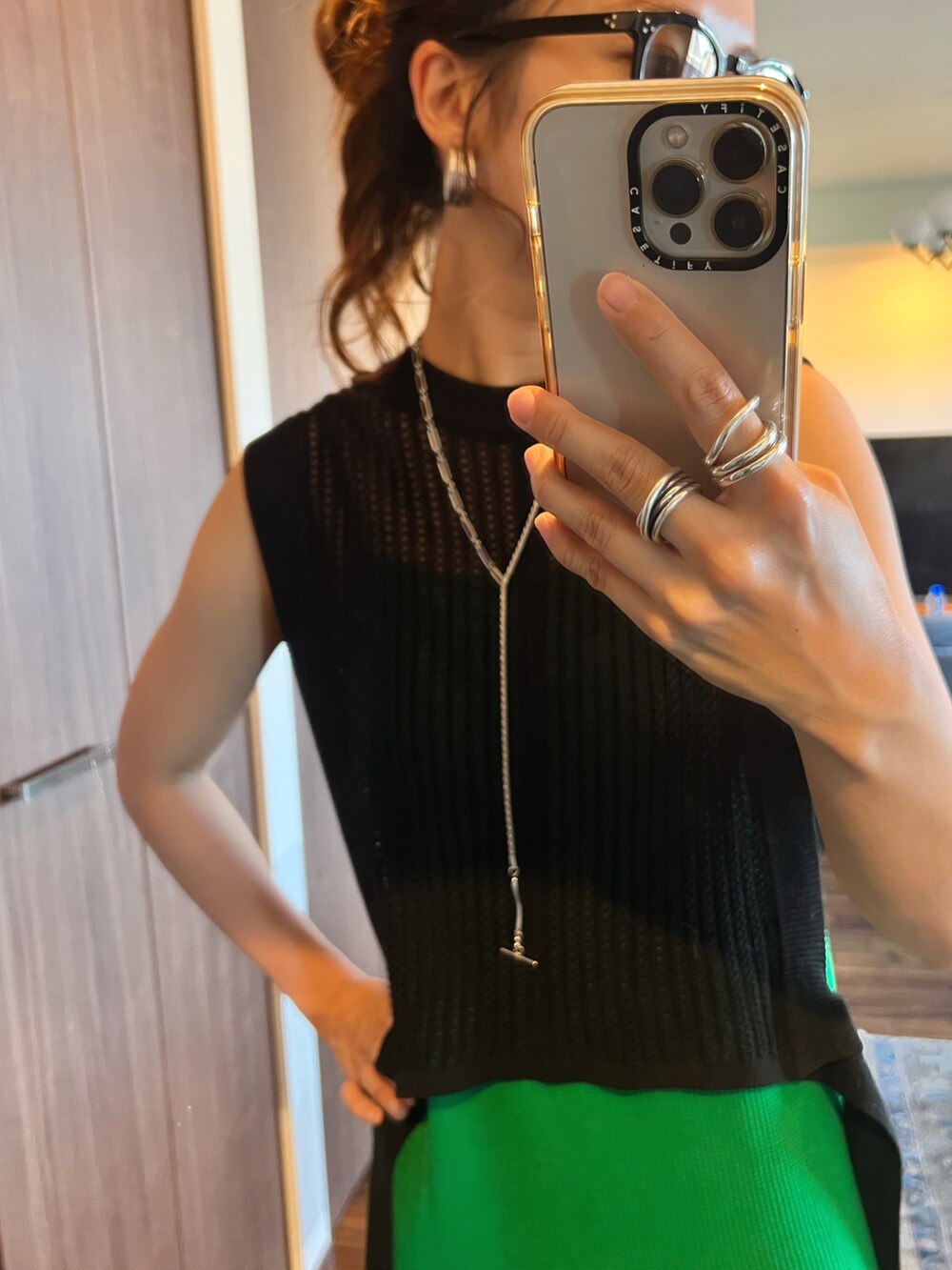 ブラック系のベスト、グリーン系のワンピース、ブラック系のサンダルを着用したレディースの夏コーディネートの3枚目の写真