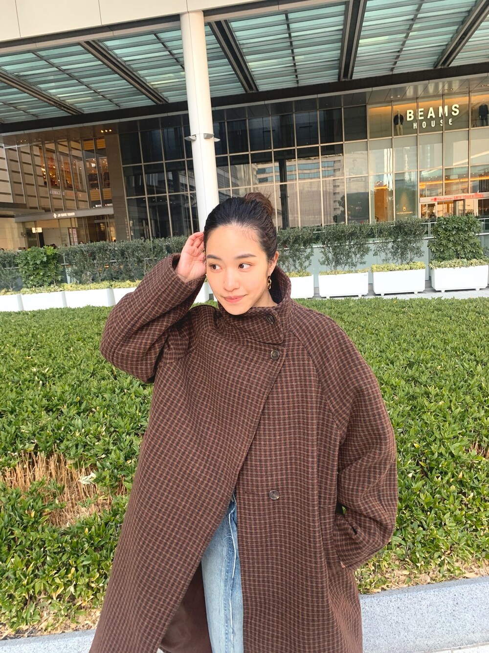 ブラウン系のその他アウター、グリーン系のニット/セーター、ブラック系のブーツを着用したレディースの冬コーディネートの3枚目の写真