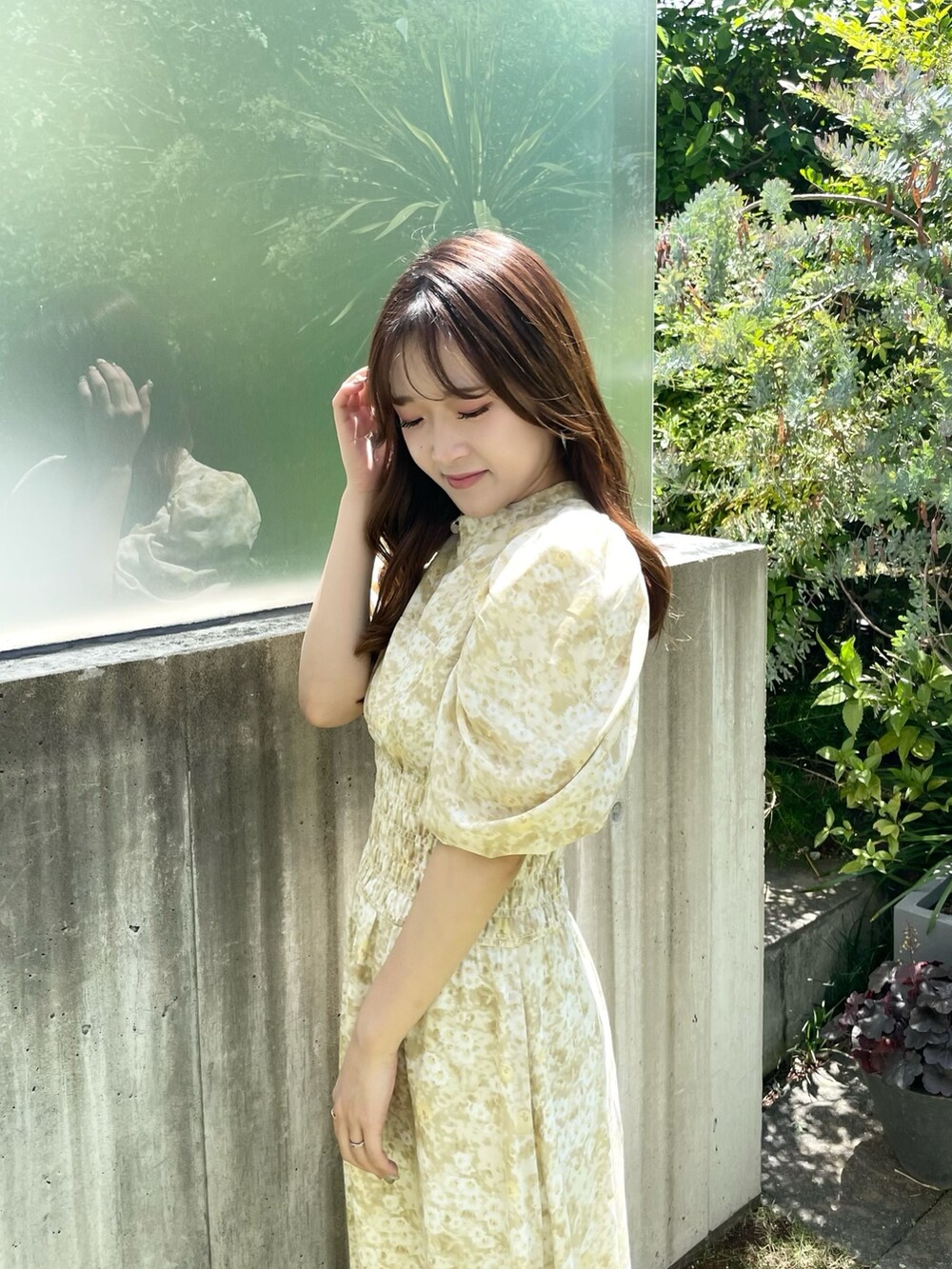 イエロー系のワンピース、ホワイト系のブーツを着用したレディースの夏コーディネートの5枚目の写真