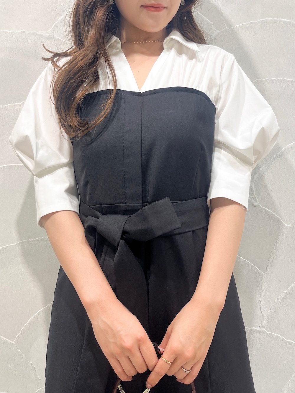 ブラック系のワンピース、レッド系のハンドバッグ、ブラウン系のブーツを着用したレディースの夏コーディネートの4枚目の写真