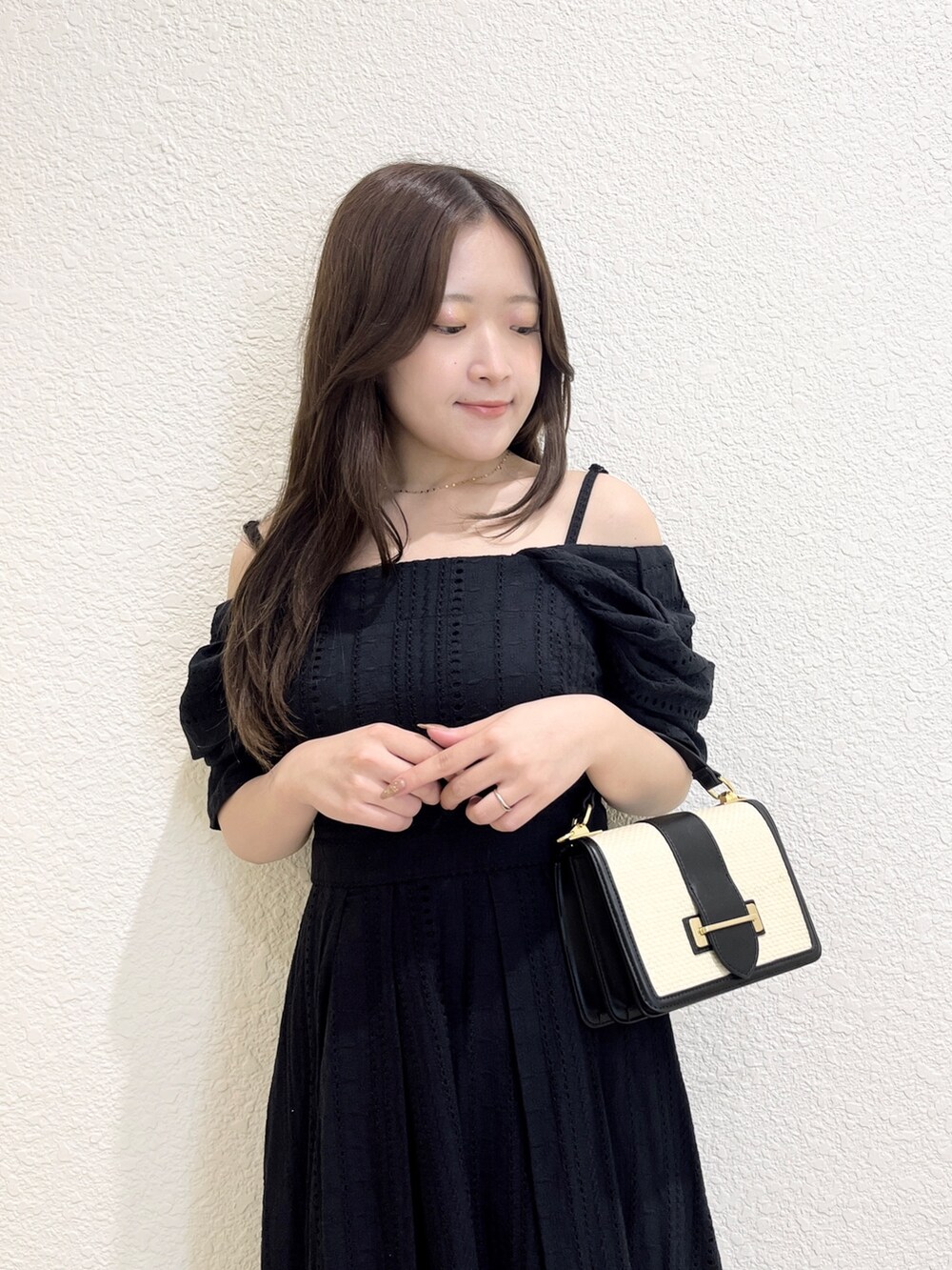 ブラック系のワンピース、その他のサンダル、ブラック系のハンドバッグを着用したレディースの夏コーディネートの4枚目の写真