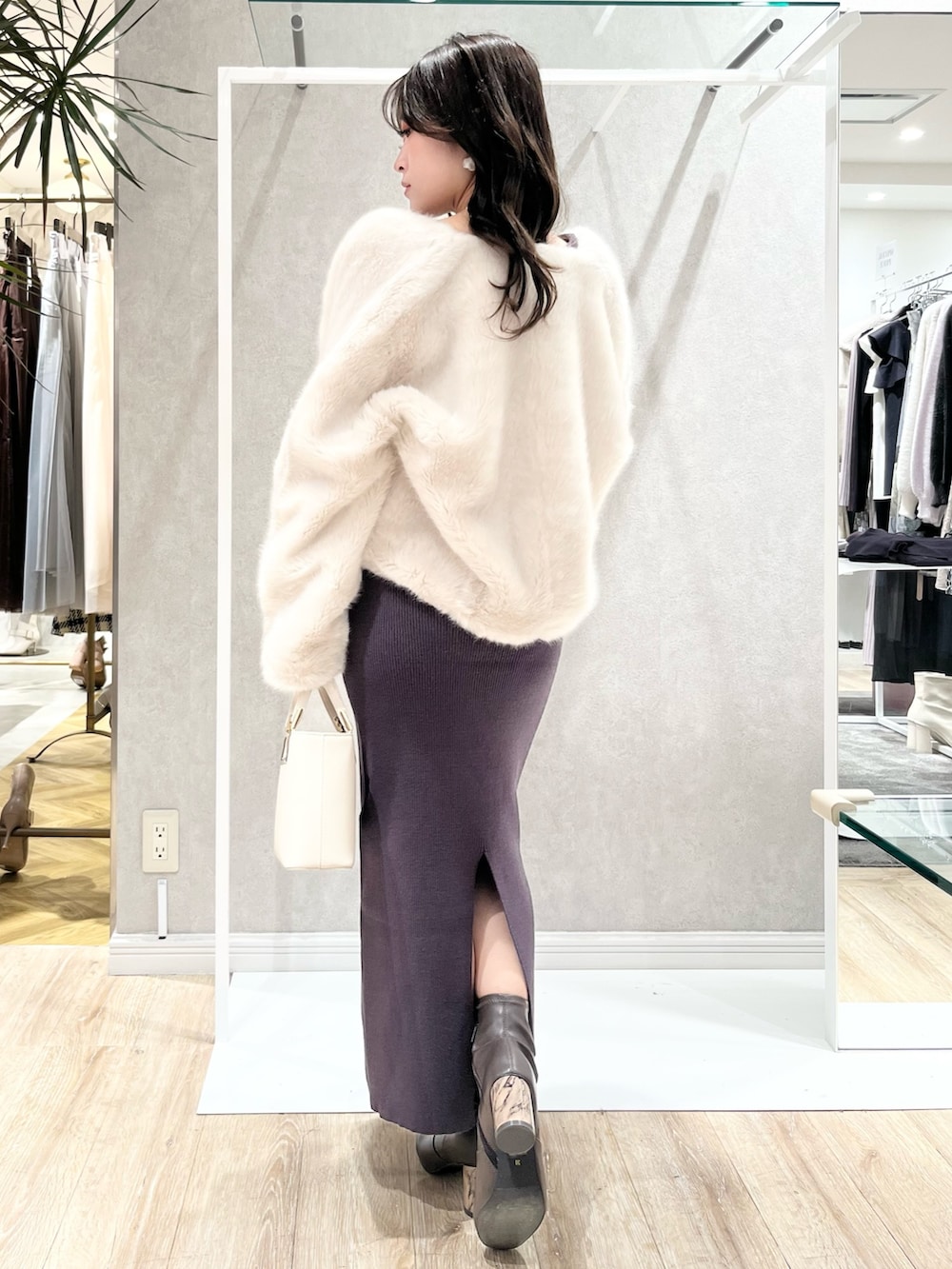 ホワイト系のその他アウター、グレー系のワンピース、ホワイト系のハンドバッグを着用したレディースの冬コーディネートの3枚目の写真