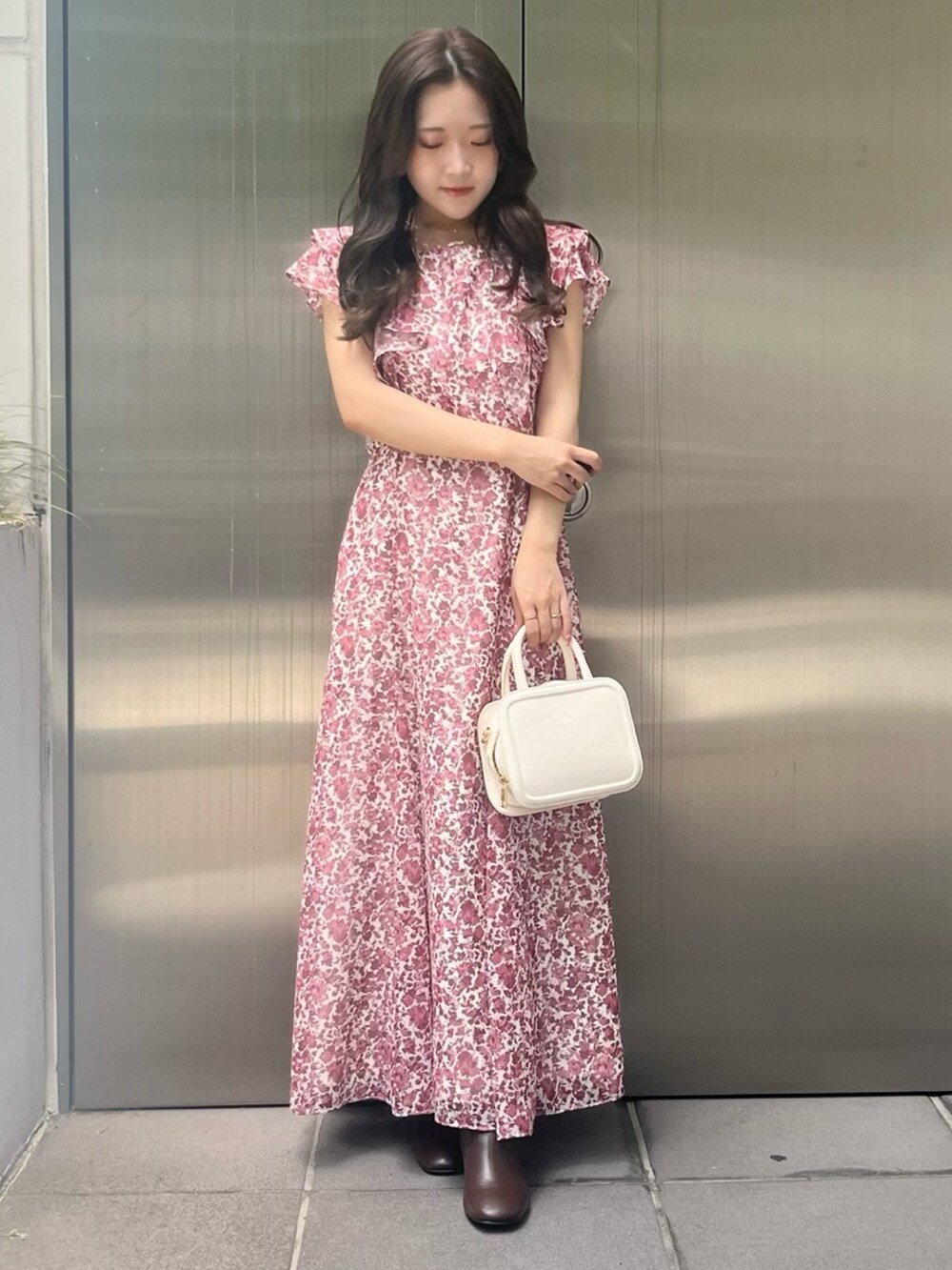 レッド系のワンピース、ホワイト系のハンドバッグを着用したレディースの夏コーディネートの4枚目の写真