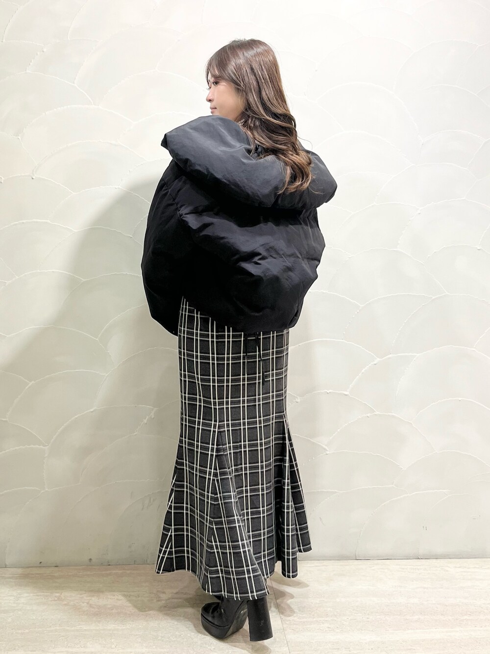 ブラック系のダウンジャケット/コート、その他のスカート、ブラック系のブーツを着用したレディースの冬コーディネートの3枚目の写真