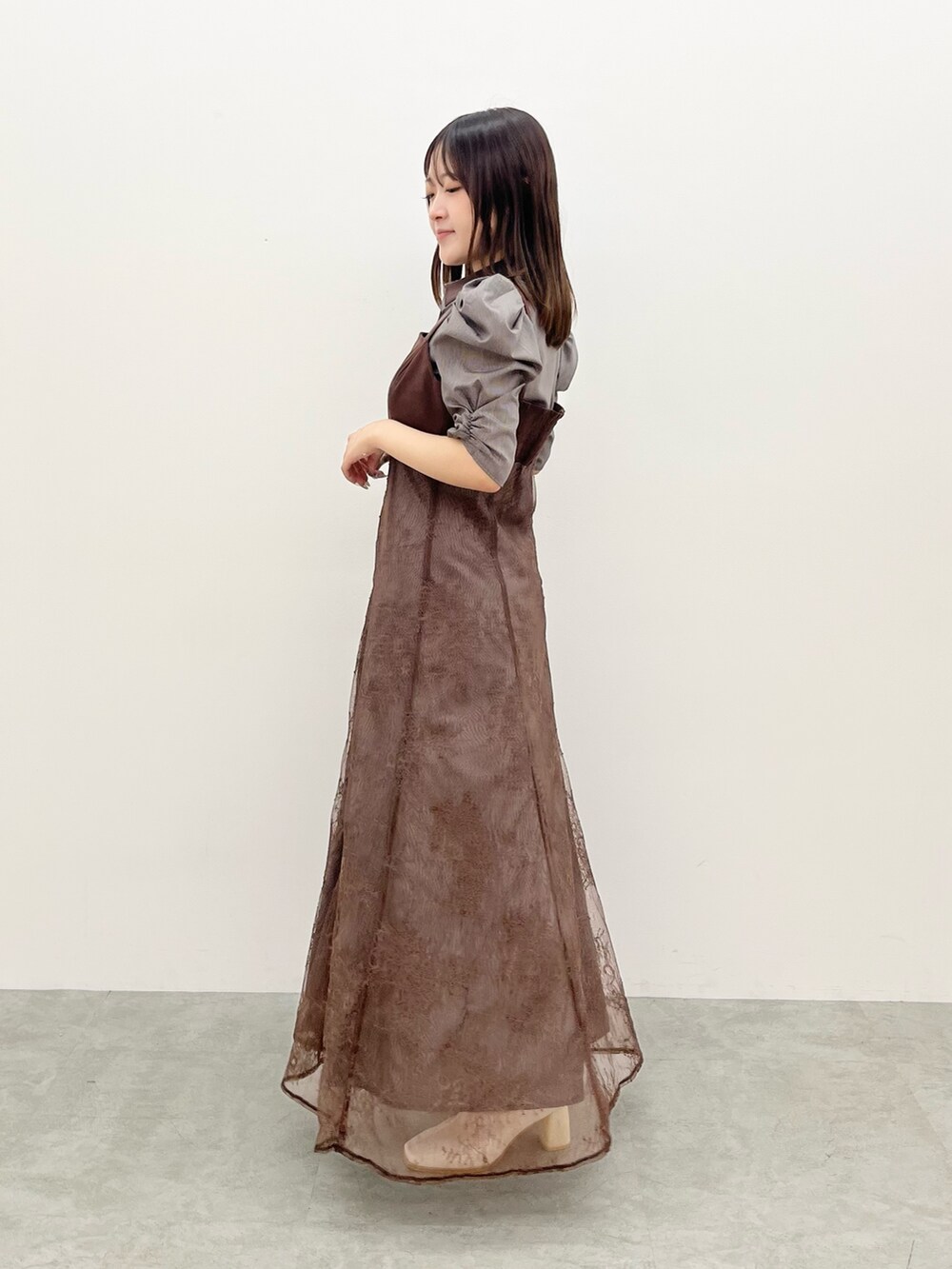 ブラウン系のワンピース、ホワイト系のブーツを着用したレディースの夏コーディネートの2枚目の写真