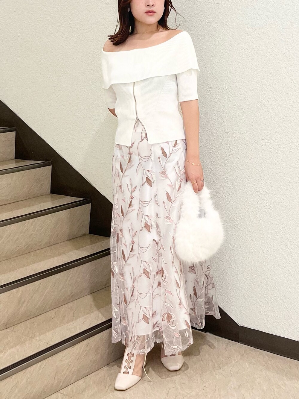 ホワイト系のニット/セーター、ホワイト系のスカート、ホワイト系のハンドバッグを着用したレディースの秋コーディネートの7枚目の写真