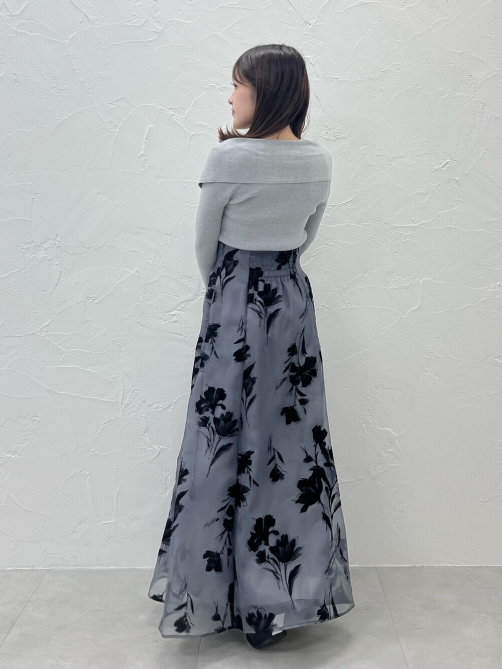 ブラック系のブーツ、ホワイト系のムートンコート、グレー系のニット/セーターを着用したレディースの秋コーディネートの4枚目の写真