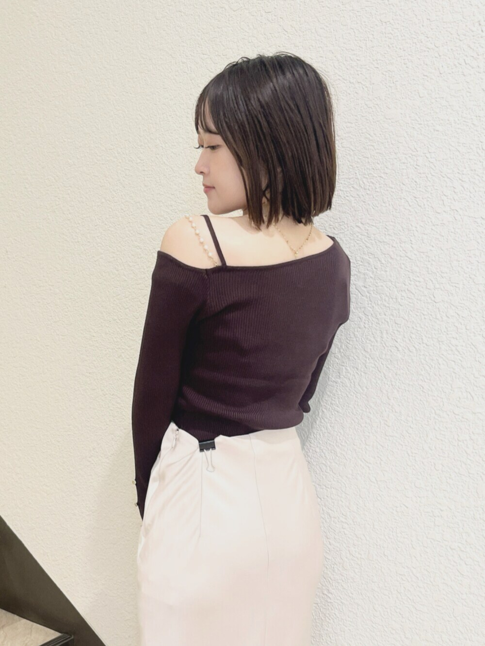 ブラウン系のニット/セーター、ピンク系のスカートを着用したレディースの秋コーディネートの5枚目の写真