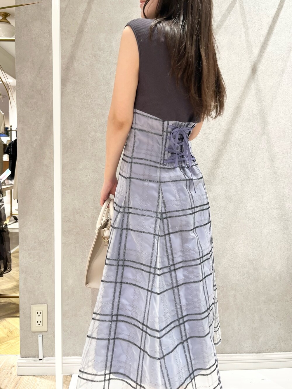 グレー系のワンピース、ベージュ系のショルダーバッグ、ブラウン系のサンダルを着用したレディースの春コーディネートの7枚目の写真