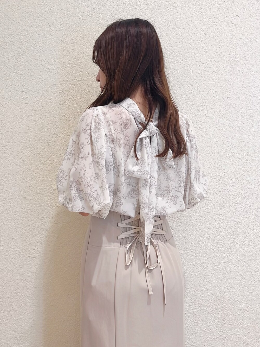 ベージュ系のシャツ/ブラウス、ベージュ系のスカート、ブラウン系のトートバッグを着用したレディースの春コーディネートの6枚目の写真