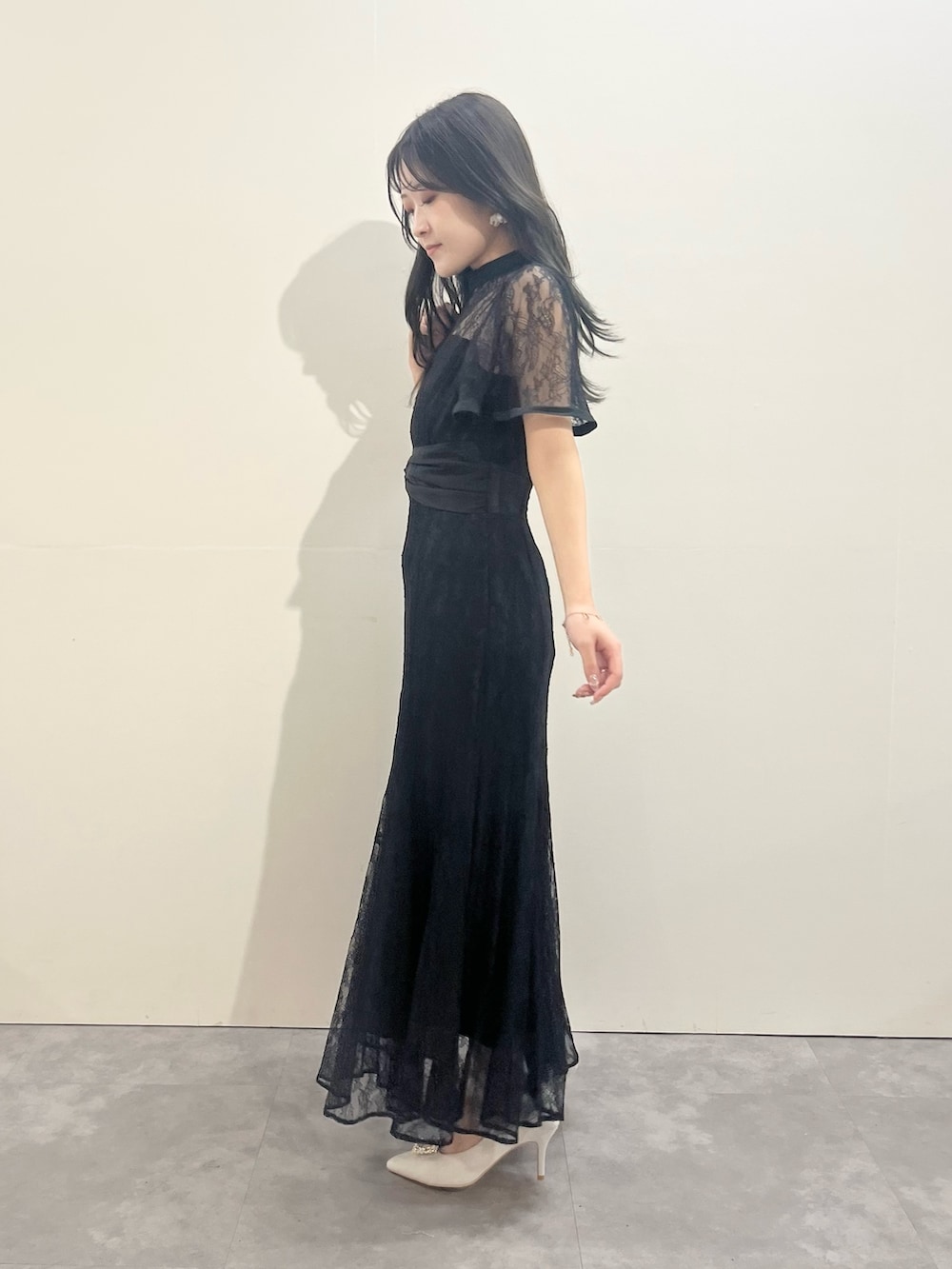 ブラック系のドレス、シルバー系のパンプスを着用したレディースの冬コーディネートの4枚目の写真