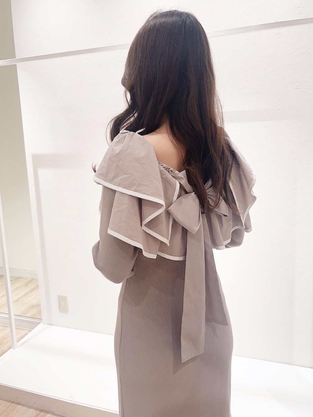 ベージュ系のワンピース、ホワイト系のその他アウター、ホワイト系のブーツを着用したレディースの秋コーディネートの5枚目の写真