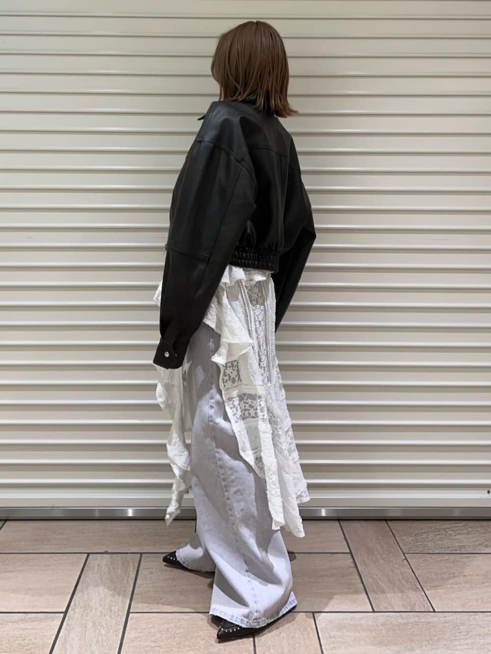 ブラウン系のサンダル、ブラウン系のブルゾン、ホワイト系のワンピースを着用したレディースの春コーディネートの2枚目の写真