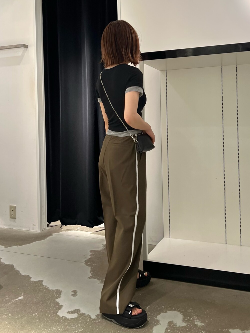 ブラック系のTシャツ/カットソー、ブラック系のサンダル、ブラック系のショルダーバッグを着用したレディースの夏コーディネートの2枚目の写真