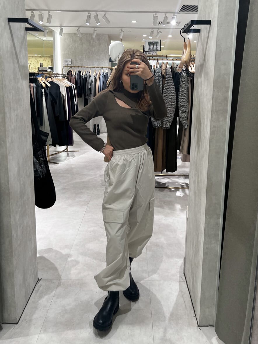 ブラック系のブーツ、ブラウン系のニット/セーター、ホワイト系のカーゴパンツを着用したレディースの秋コーディネートの6枚目の写真