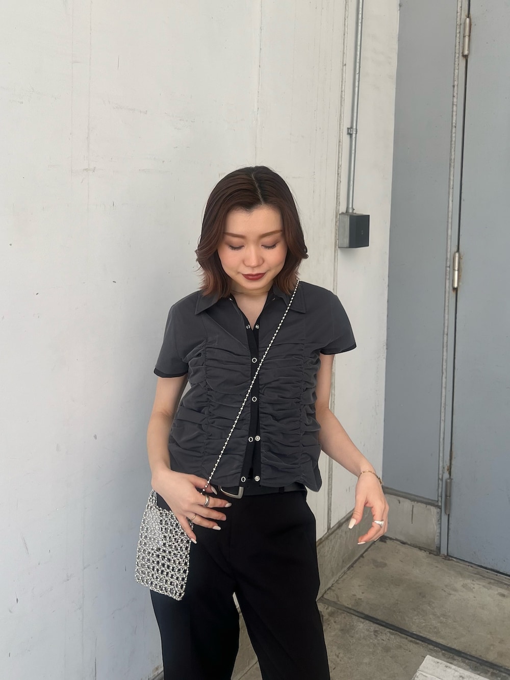 ブラック系のサンダル、ブラック系のシャツ/ブラウス、シルバー系のショルダーバッグを着用したレディースの春コーディネートの5枚目の写真