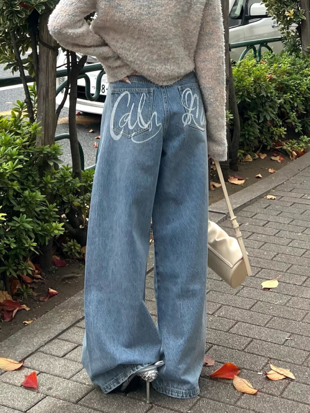 イエロー系のハンドバッグ、ブルー系のその他パンツ、その他のカーディガン/ボレロを着用したレディースの冬コーディネートの7枚目の写真