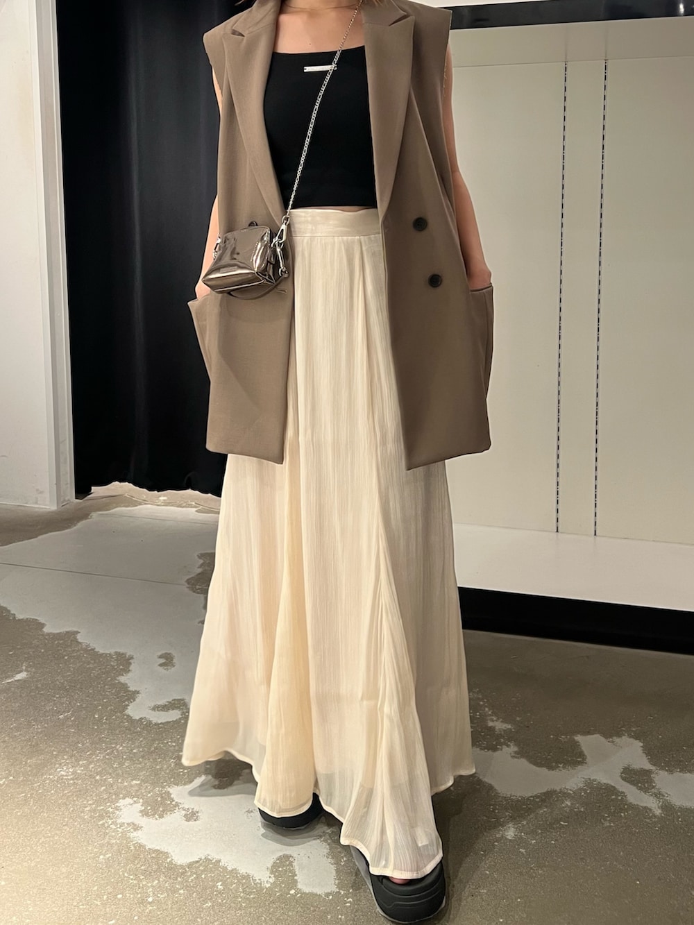 ブラック系のサンダル、ホワイト系のスカート、ゴールド系のショルダーバッグを着用したレディースの夏コーディネートの5枚目の写真