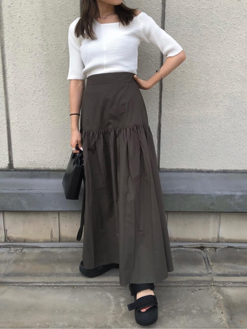 ブラック系のサンダル、ブラック系のショルダーバッグ、ホワイト系のニット/セーターを着用したレディースの夏コーディネートの8枚目の写真