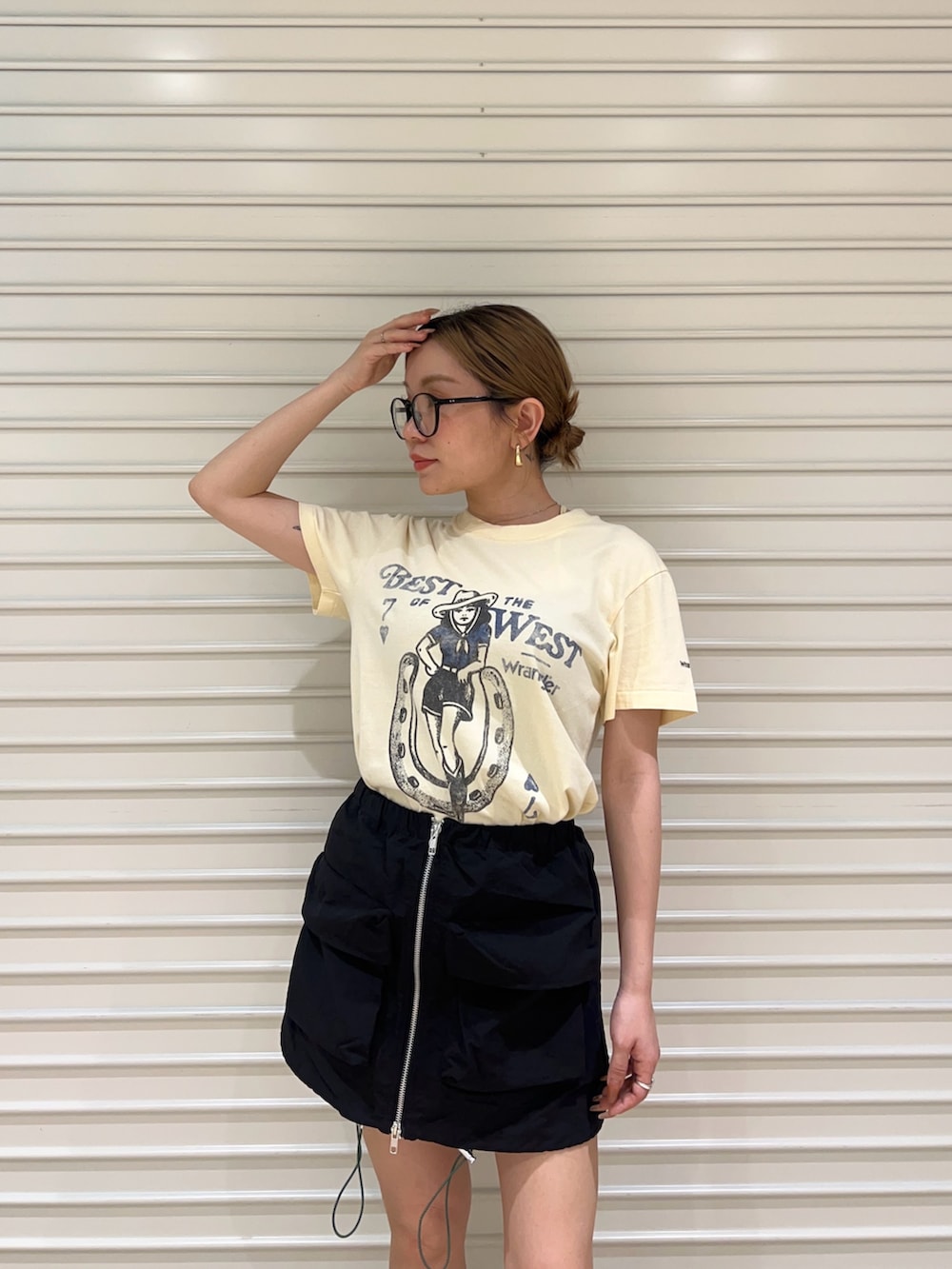 イエロー系のTシャツ/カットソー、ブラック系のスカートを着用したレディースの春コーディネートの4枚目の写真