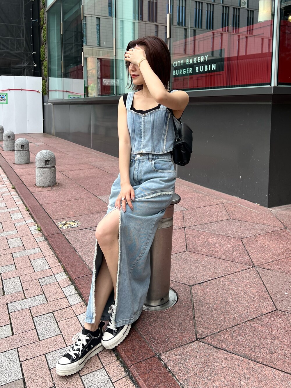 ブルー系のシャツ/ブラウス、ブルー系のデニムスカート、ブラック系のニット/セーターを着用したレディースの夏コーディネートの2枚目の写真