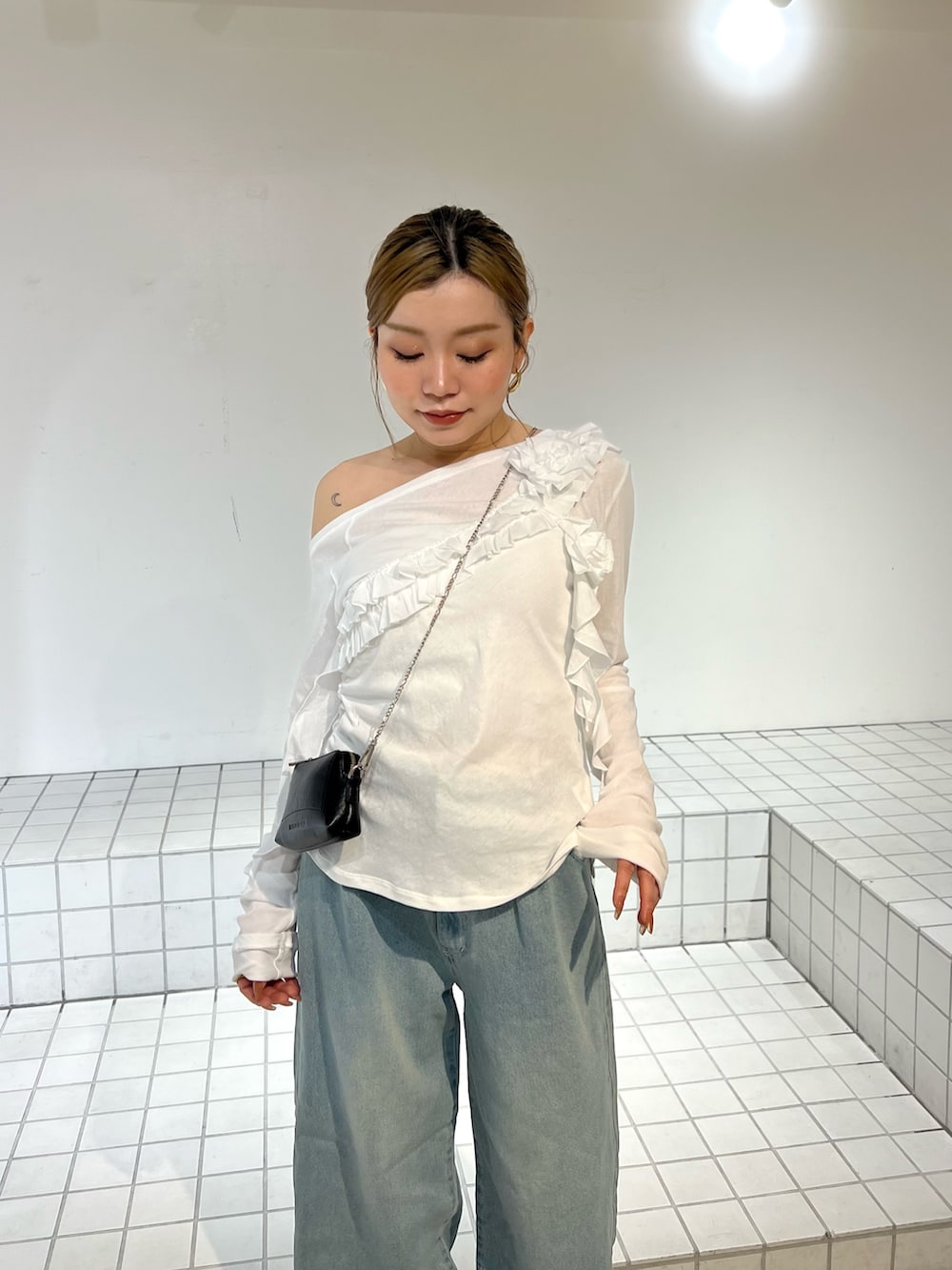 ホワイト系のTシャツ/カットソー、ブルー系のデニムパンツ、ブラック系のサンダルを着用したレディースの春コーディネートの4枚目の写真
