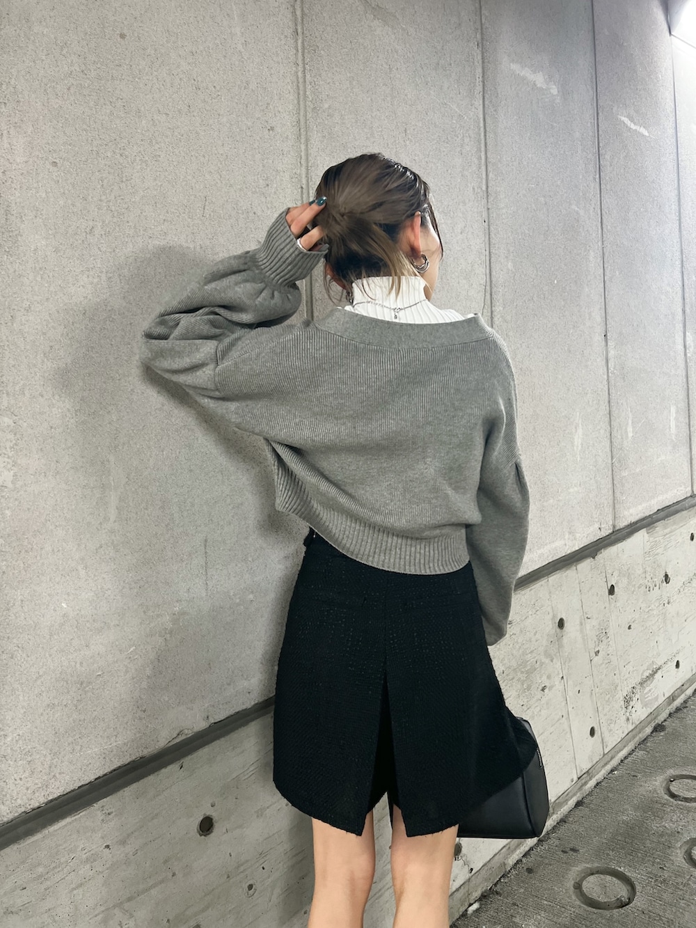 グレー系のカーディガン/ボレロ、ブラック系のブーツ、ホワイト系のニット/セーターを着用したレディースの冬コーディネートの5枚目の写真