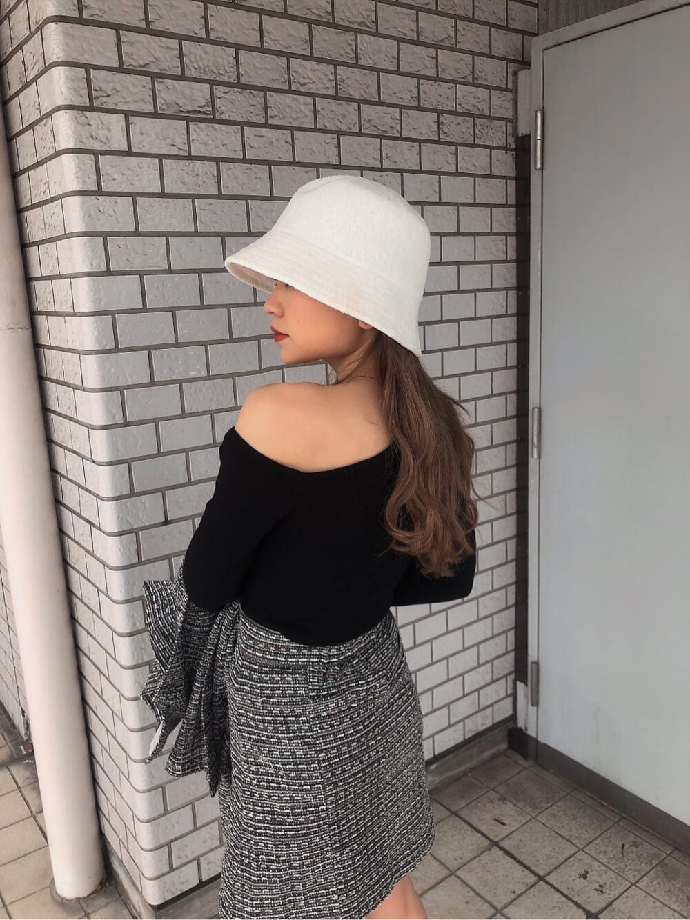 ブラック系のその他アウター、ブラック系のスカート、ブラック系のブーツを着用したレディースの春コーディネートの7枚目の写真