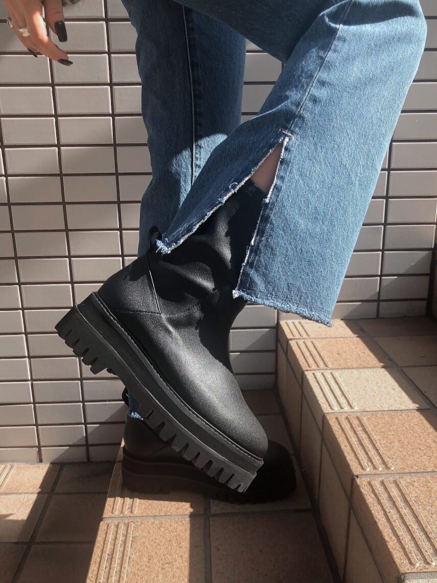 ブルー系のデニムパンツ、ブラック系のハンドバッグ、ブラック系のニット/セーターを着用したレディースの秋コーディネートの6枚目の写真