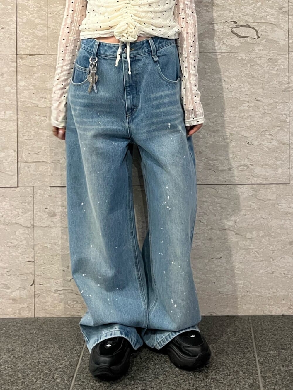 ホワイト系のTシャツ/カットソー、ブルー系のデニムパンツ、ブラック系のキャップを着用したレディースの春コーディネートの6枚目の写真