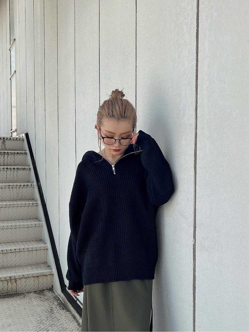 グリーン系のスカート、ブラック系のブーツ、ブラック系のニット/セーターを着用したレディースの秋コーディネートの6枚目の写真