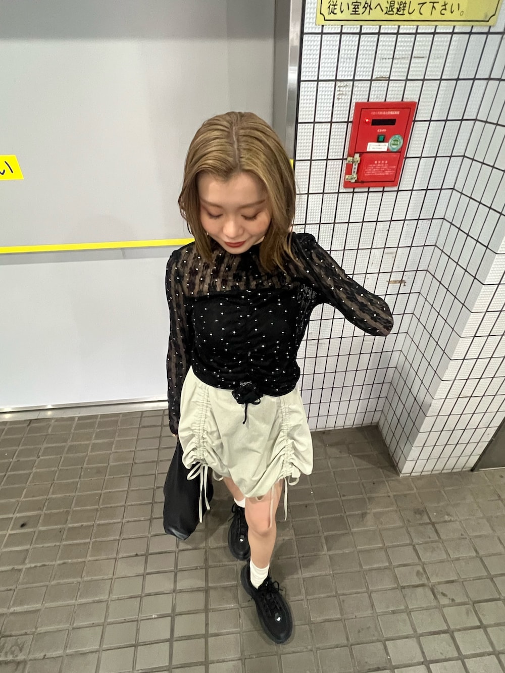 ブラック系のTシャツ/カットソー、グリーン系のスカートを着用したレディースの春コーディネートの5枚目の写真