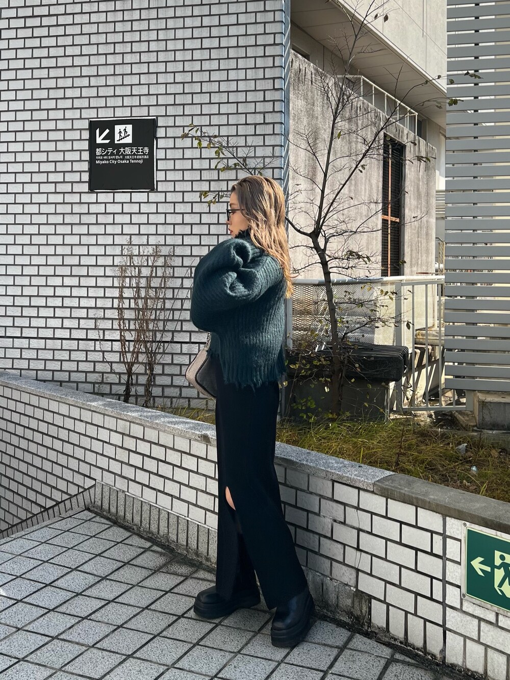 グリーン系のニット/セーター、その他のショルダーバッグ、ブラック系のワンピースを着用したレディースの秋コーディネートの2枚目の写真