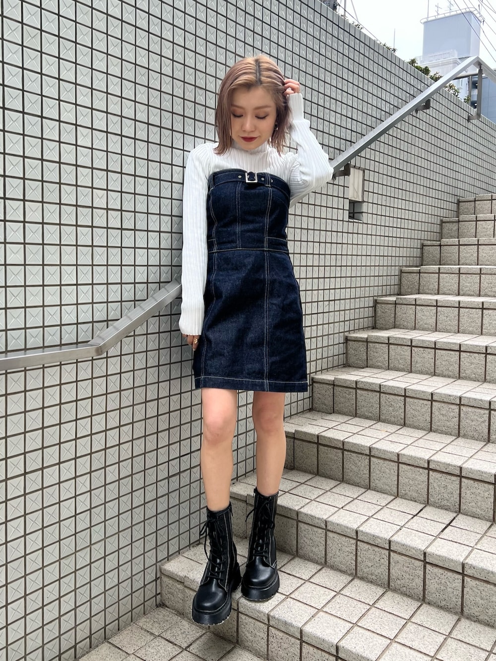 ホワイト系のニット/セーター、ブルー系のワンピース、ブラック系のブーツを着用したレディースの冬コーディネートの3枚目の写真