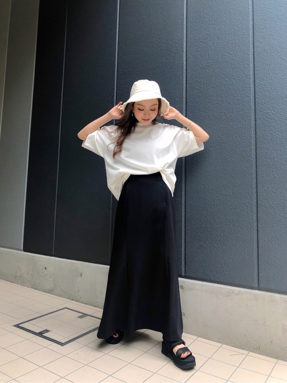 ブラック系のサンダル、ホワイト系のTシャツ/カットソー、ホワイト系のハットを着用したレディースの春コーディネートの3枚目の写真