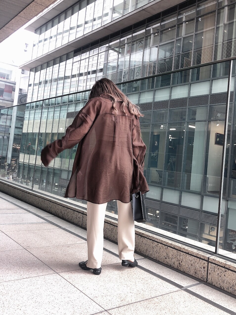 ベージュ系のシャツ/ブラウス、ベージュ系のその他パンツ、ブラック系のショルダーバッグを着用したレディースの春コーディネートの3枚目の写真